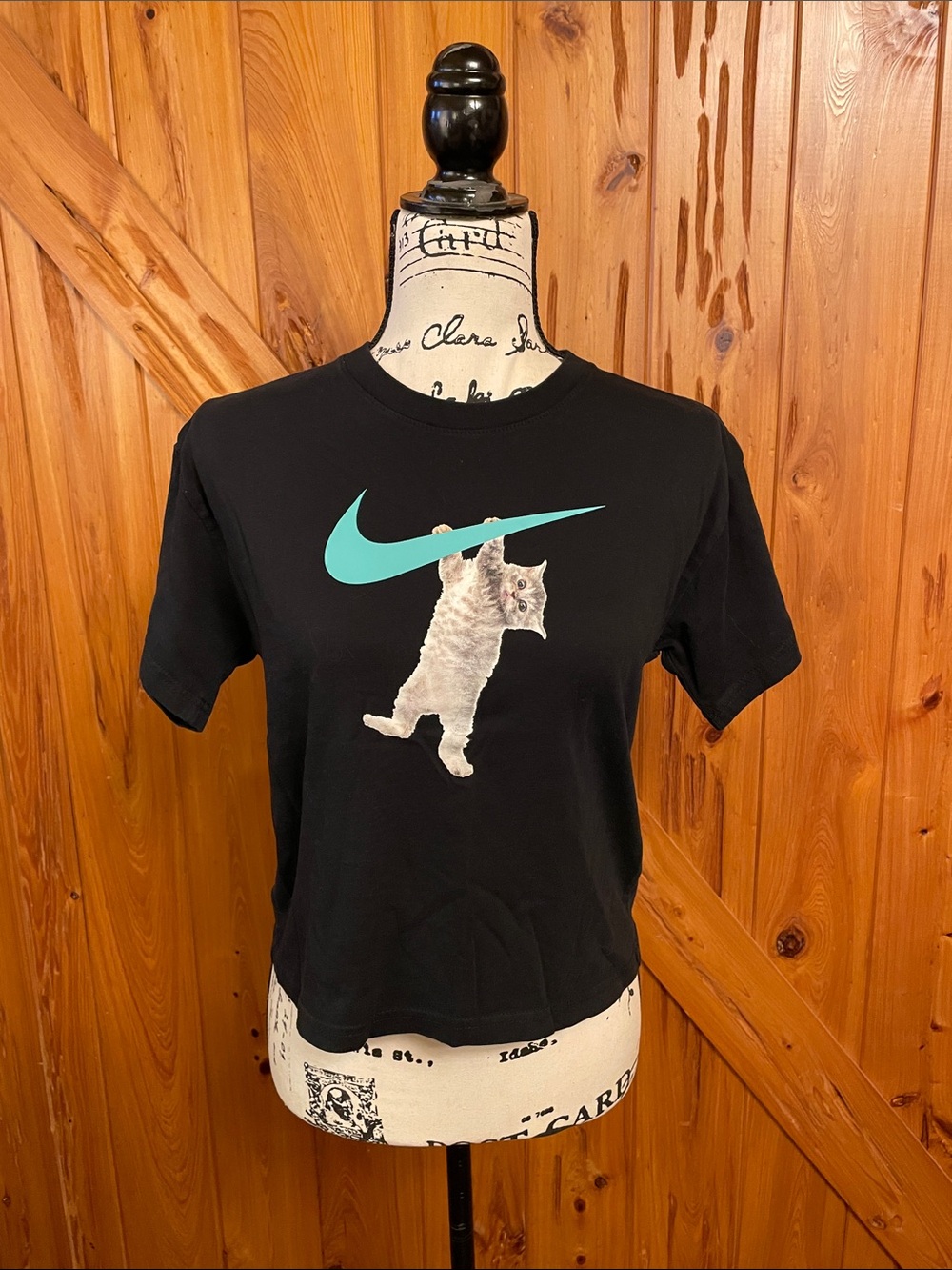 Nike Black Tee with Teal Swoosh and Cat Graphic fits like a women’s small